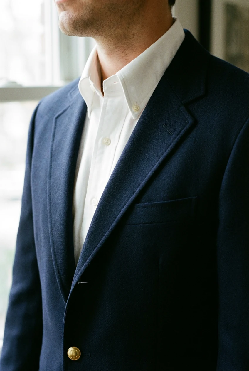 closeup navy blazer over crisp white oxford collar
