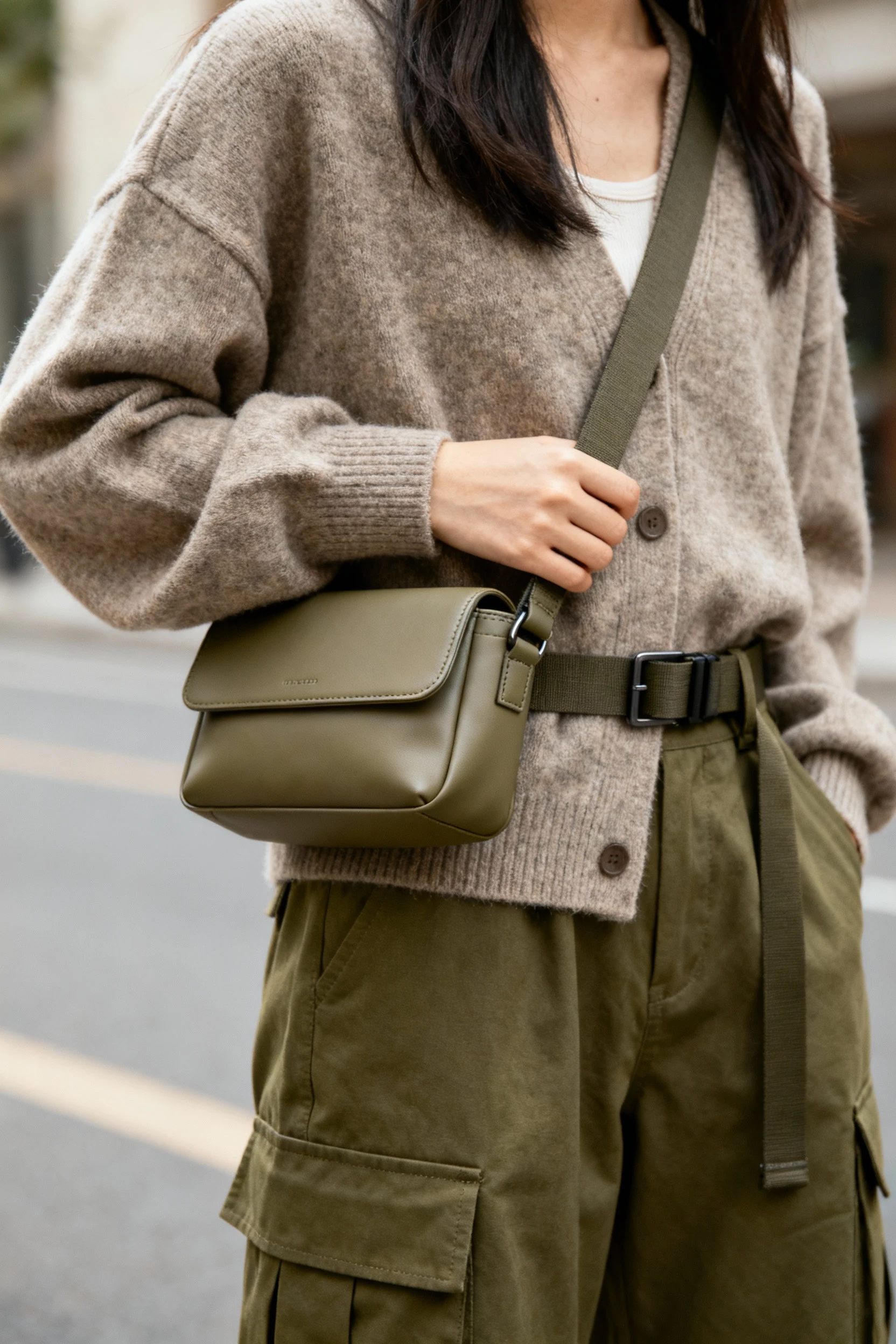 closeup female belt bag crossbody on cardigan, olive cargos