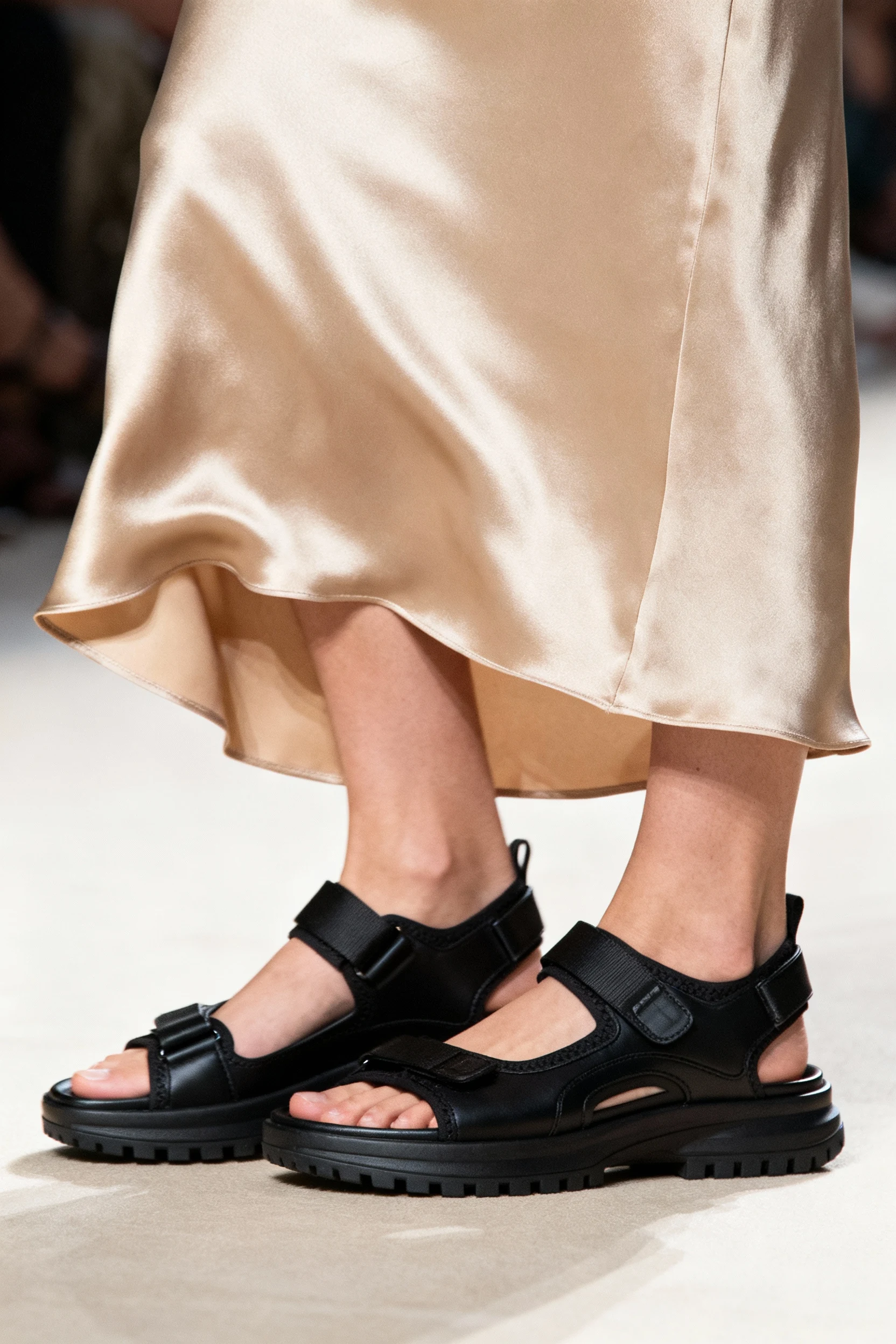 closeup black sporty sandals, champagne slip dress hem