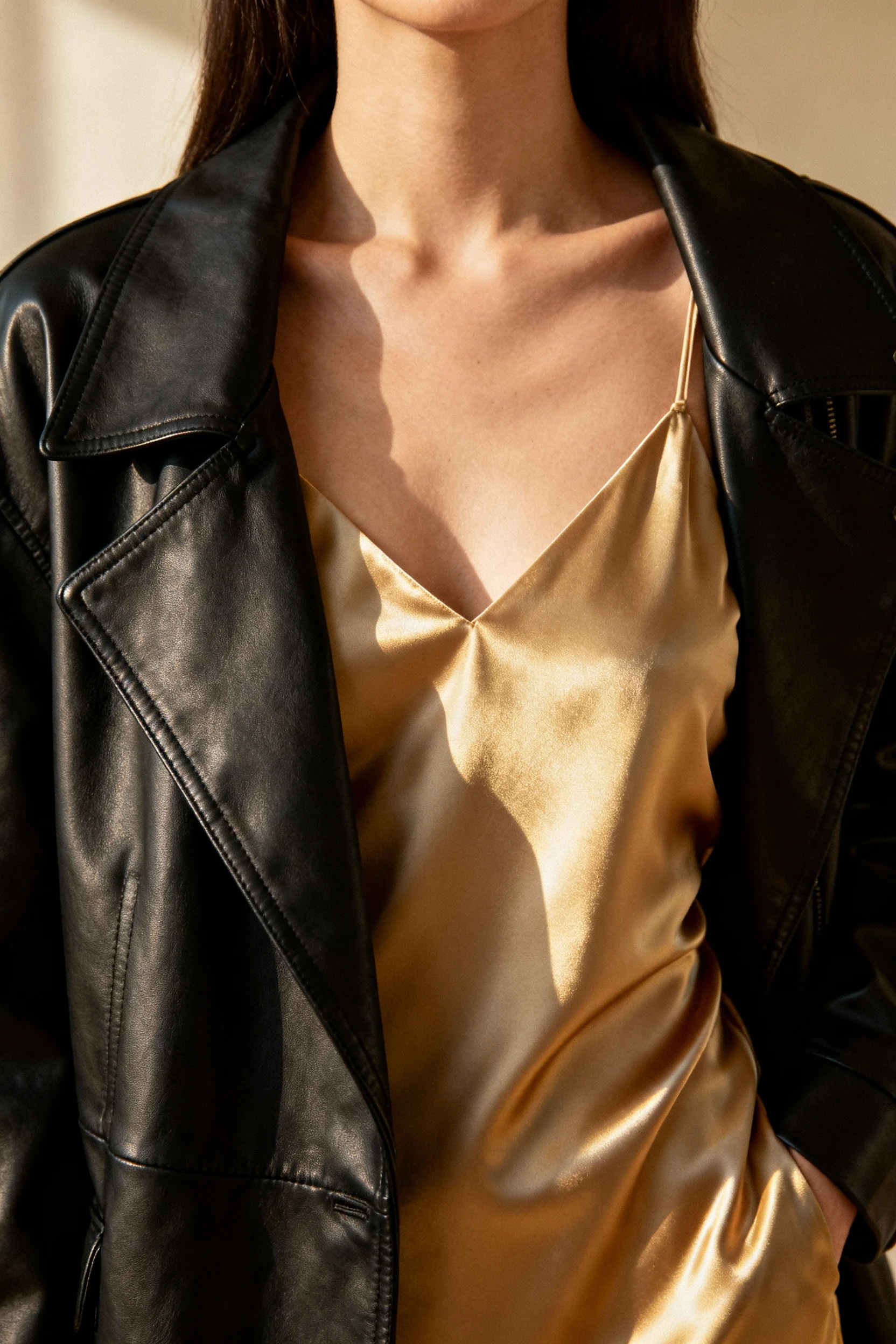2. Closeup female satin slip dress under black leather jacket