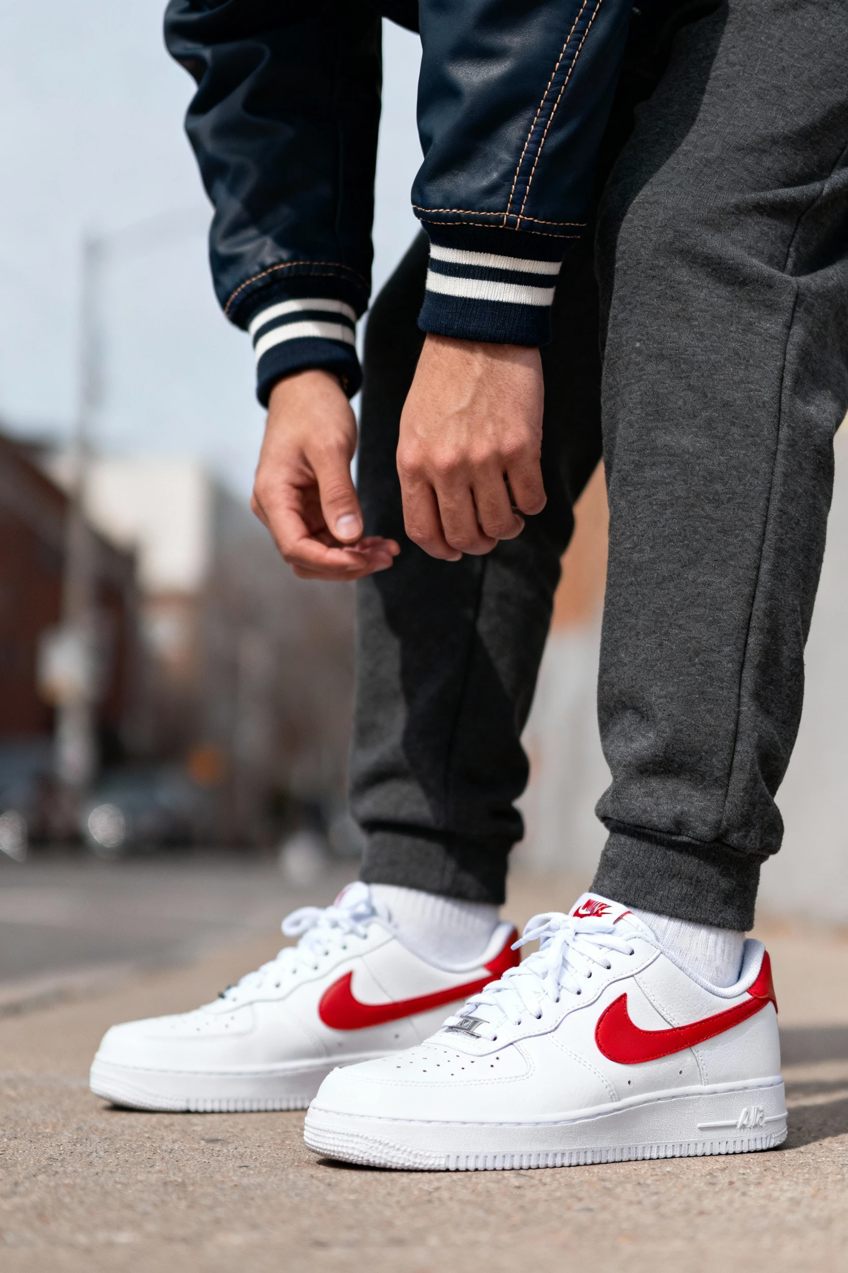 closeup male varsity jacket sleeve, straight-leg joggers, AF1s