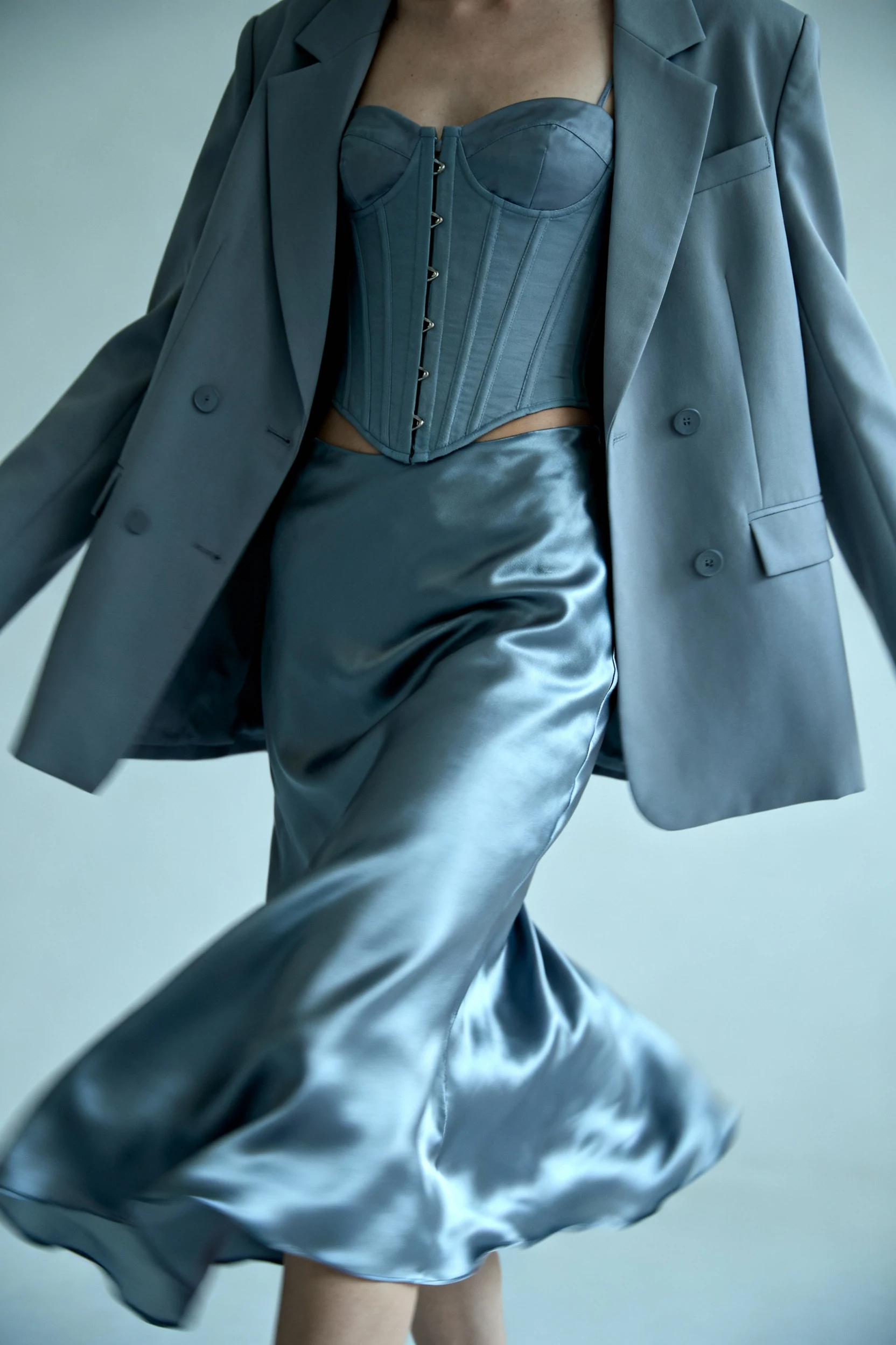 2. closeup of satin slip skirt swish, corset top, blazer