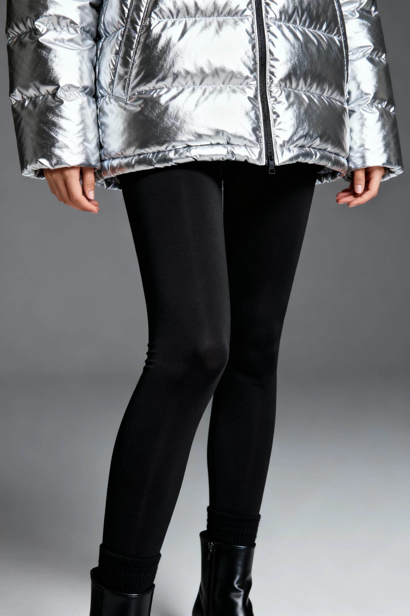 3. female torso in metallic silver puffer, black leggings, sock boots