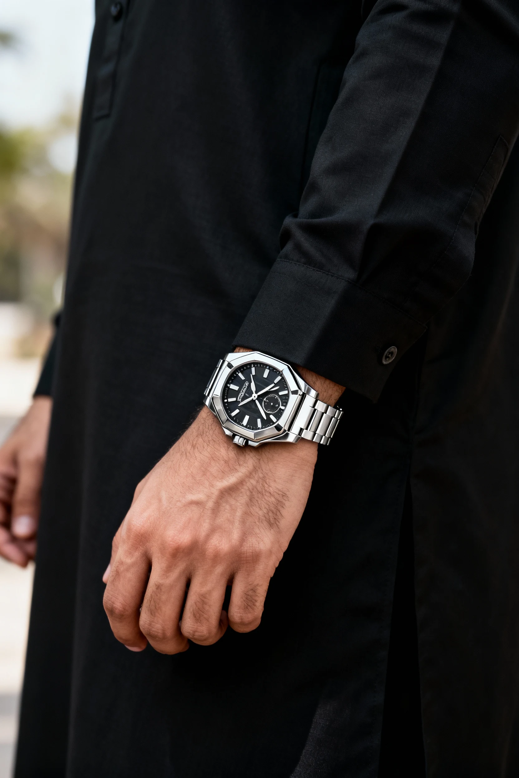 male wrist in black pathani suit, statement watch
