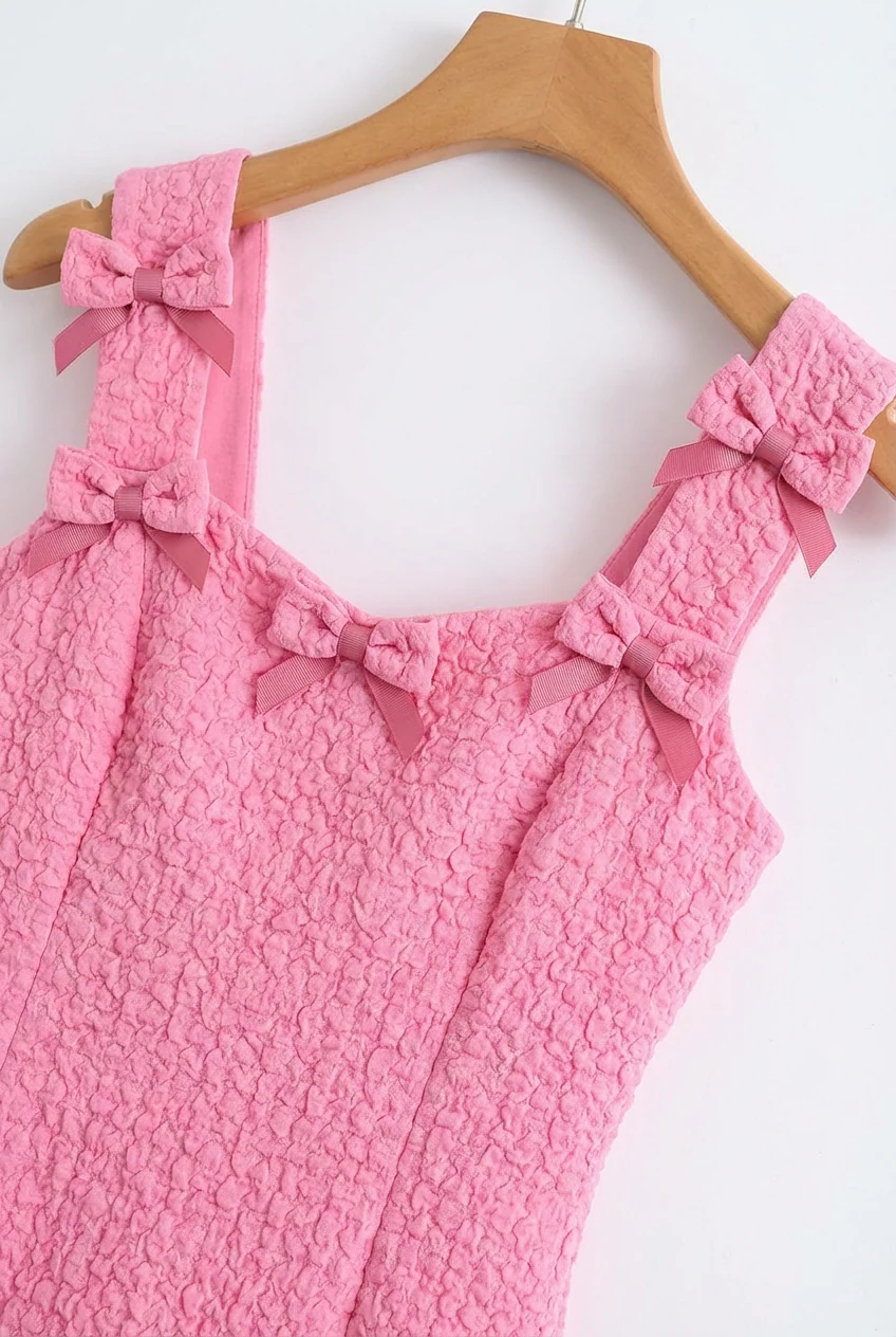 closeup of bubblegum pink mini dress with decorative bows