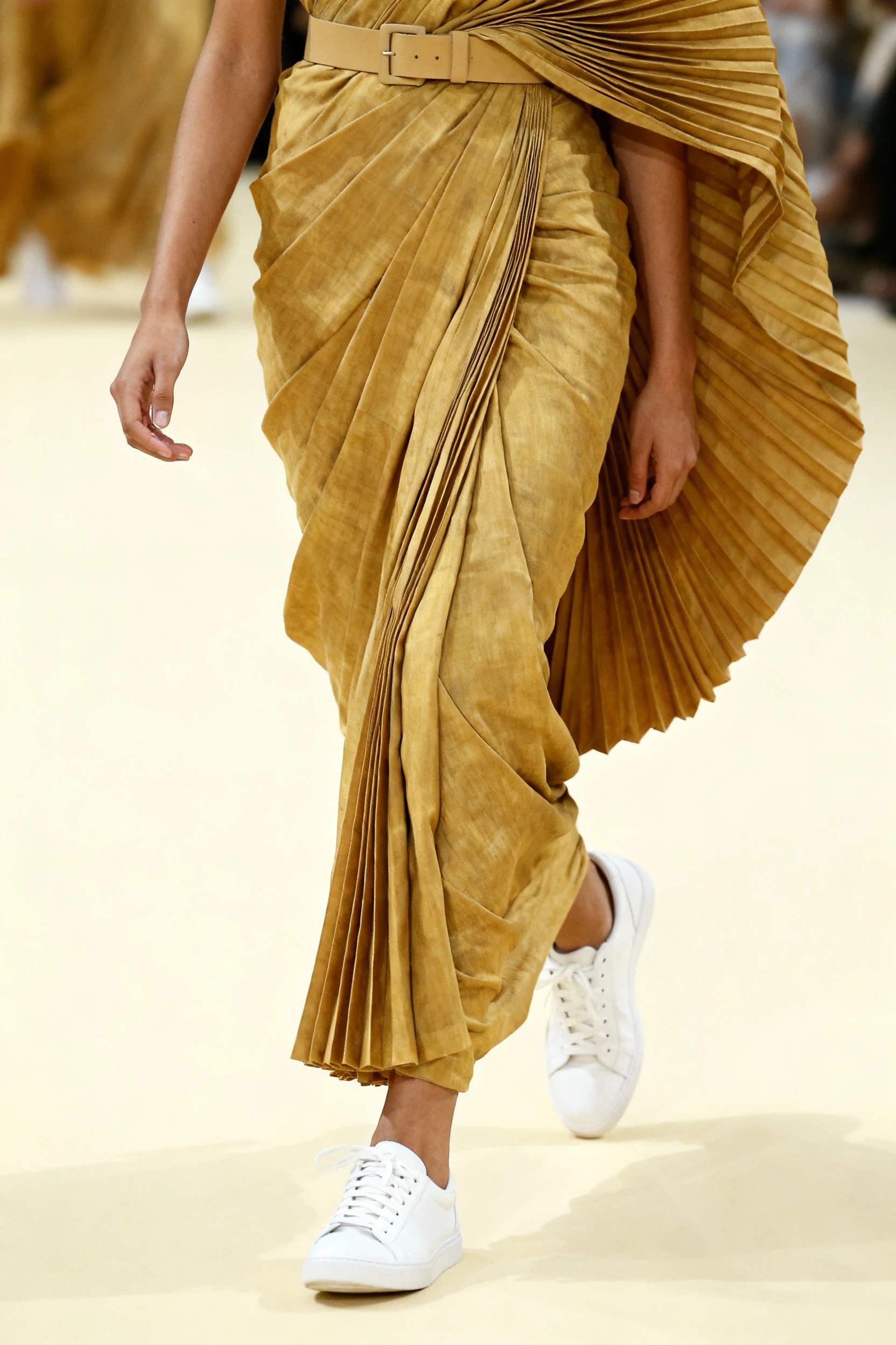female closeup saree pleats with belt and white sneakers