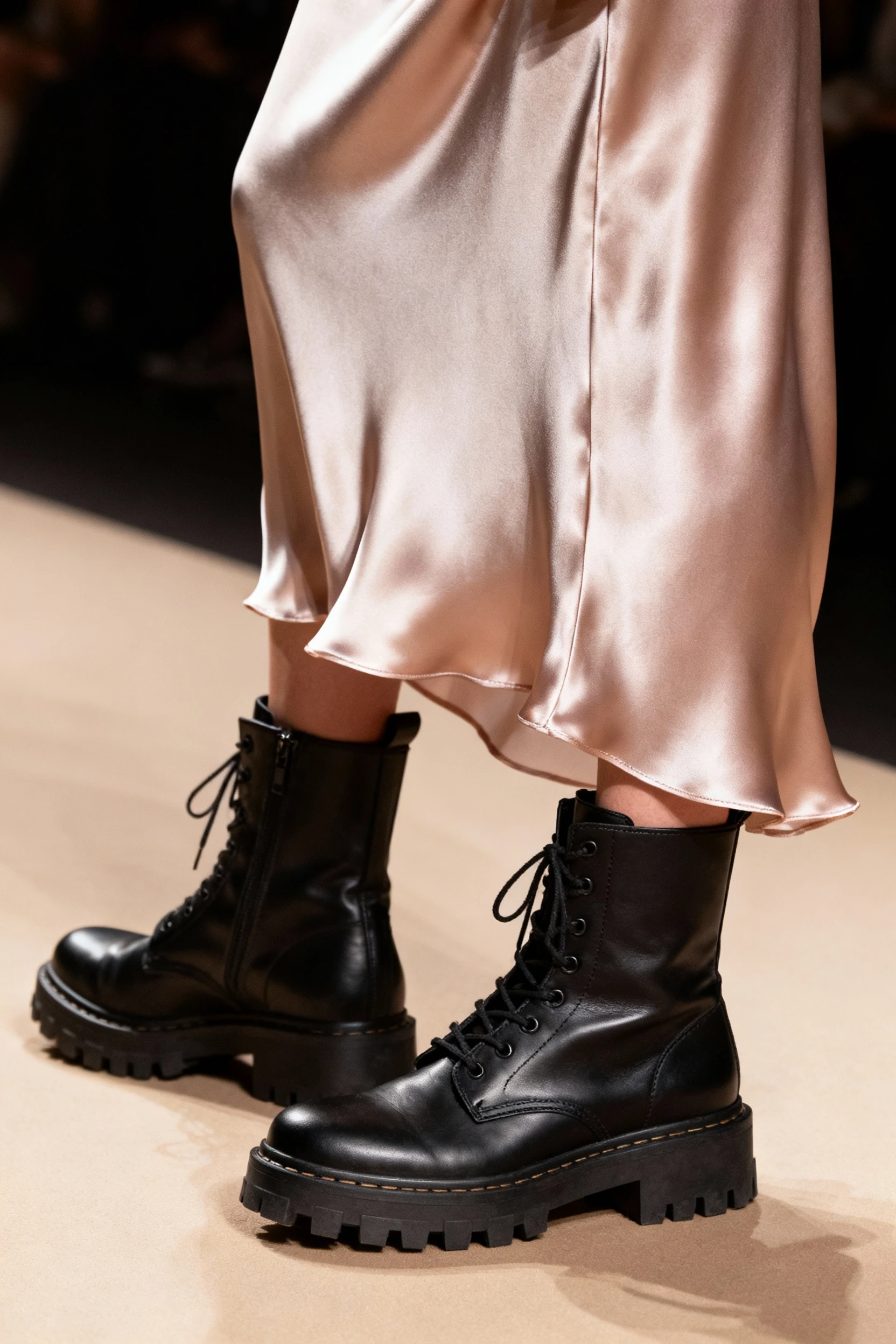 closeup satin slip skirt hem with black combat boots