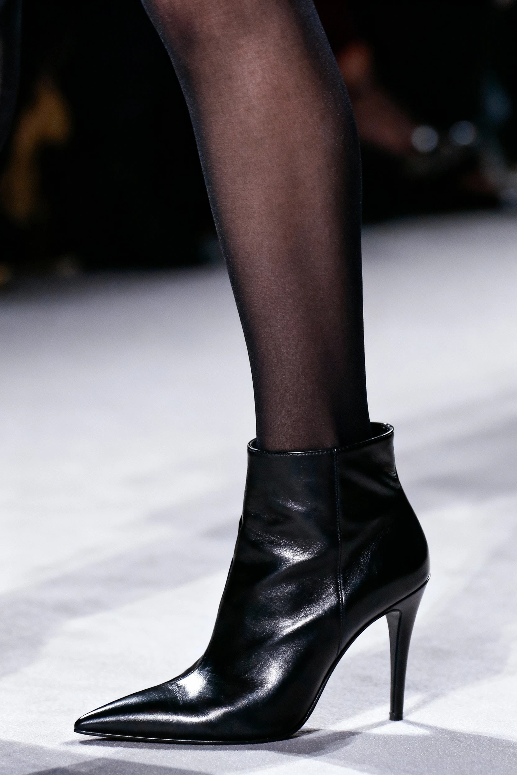 closeup sheer black tights with sleek ankle boots