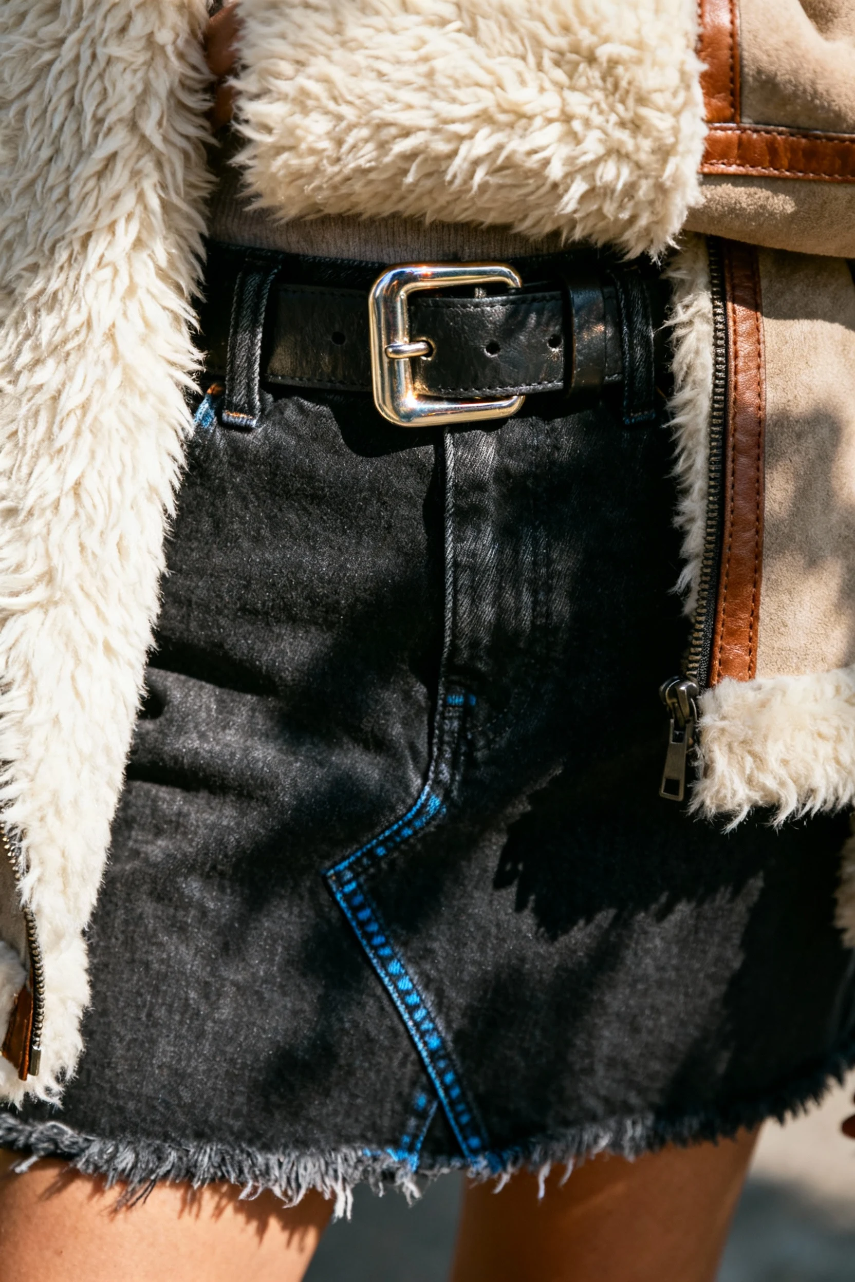 closeup chunky buckle belt over dark denim skirt, shearling jacket