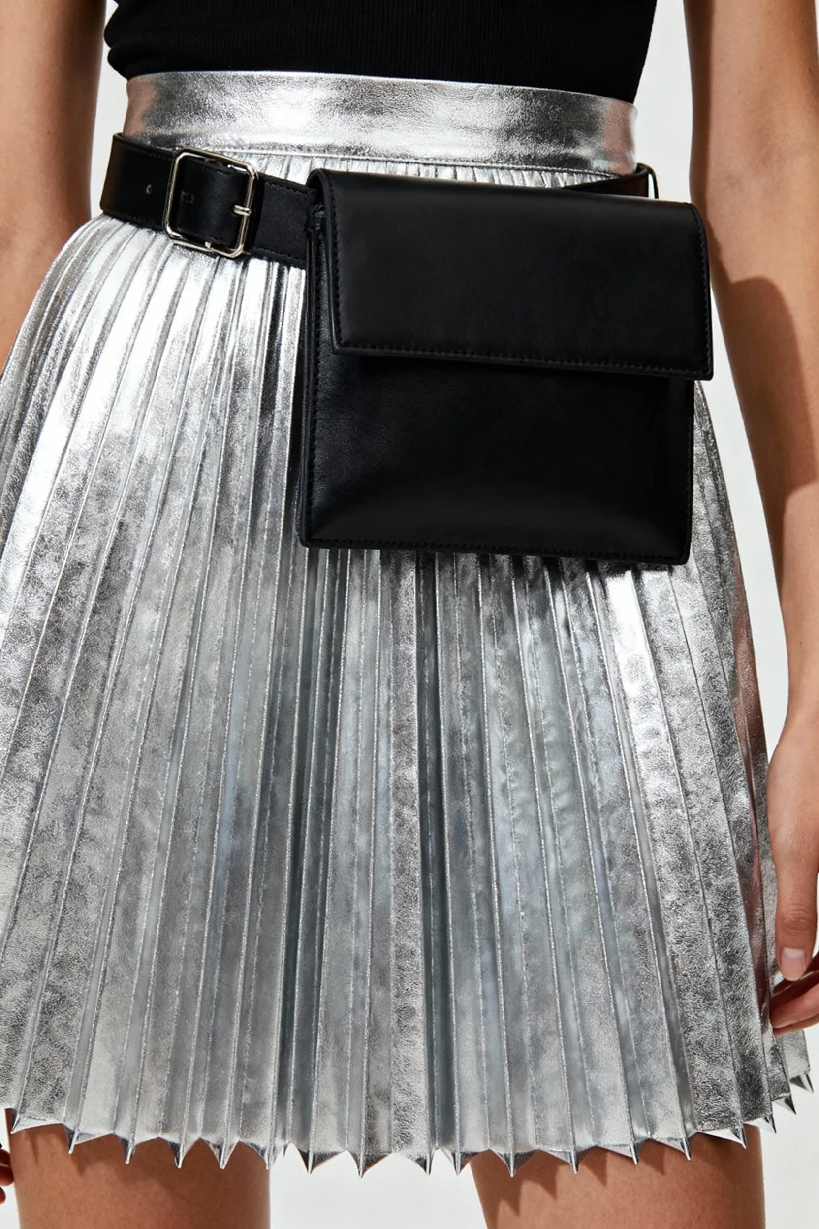 closeup silver metallic pleated skirt, black belt bag cinched waist