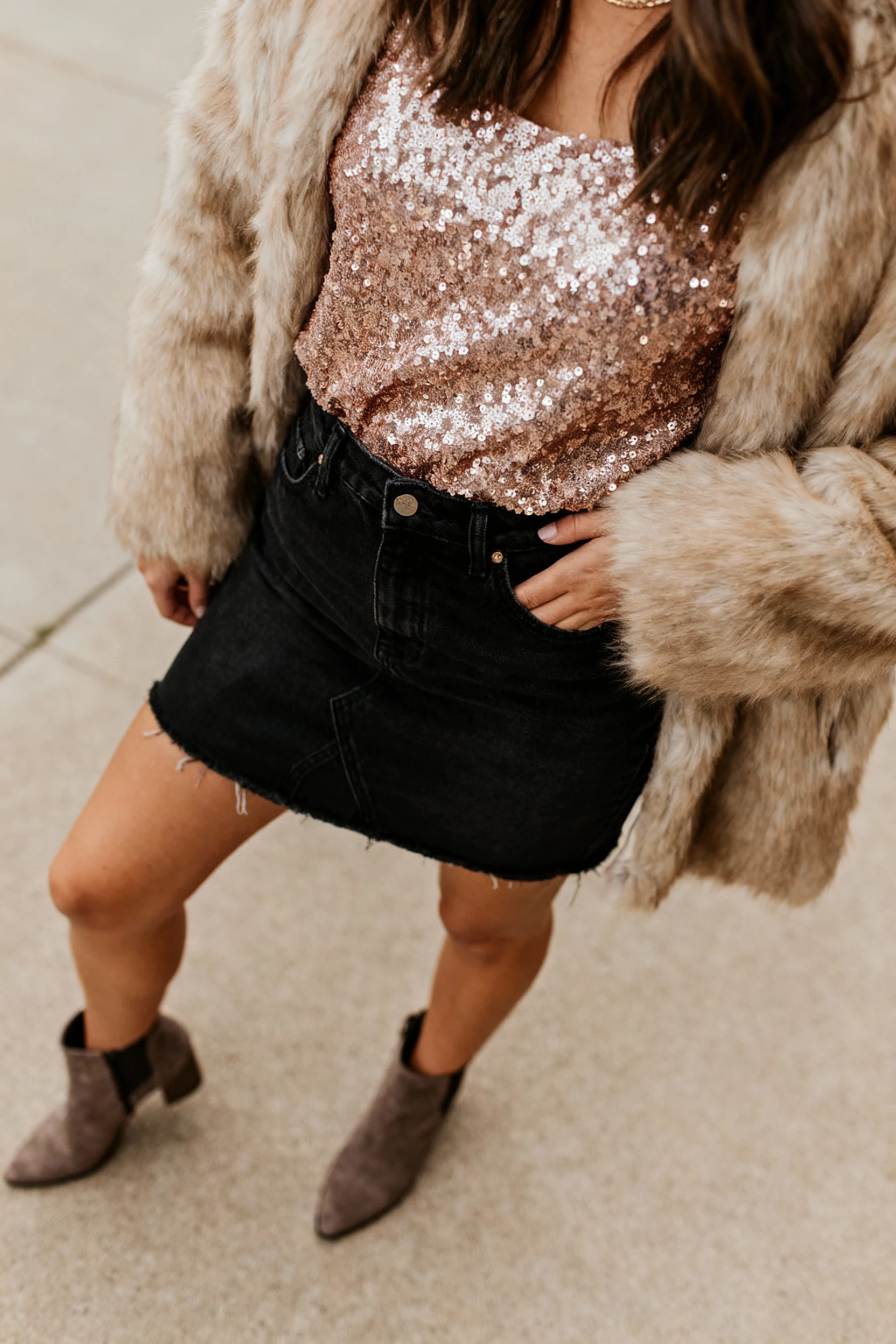 female sequin top, black denim skirt, faux fur jacket, booties