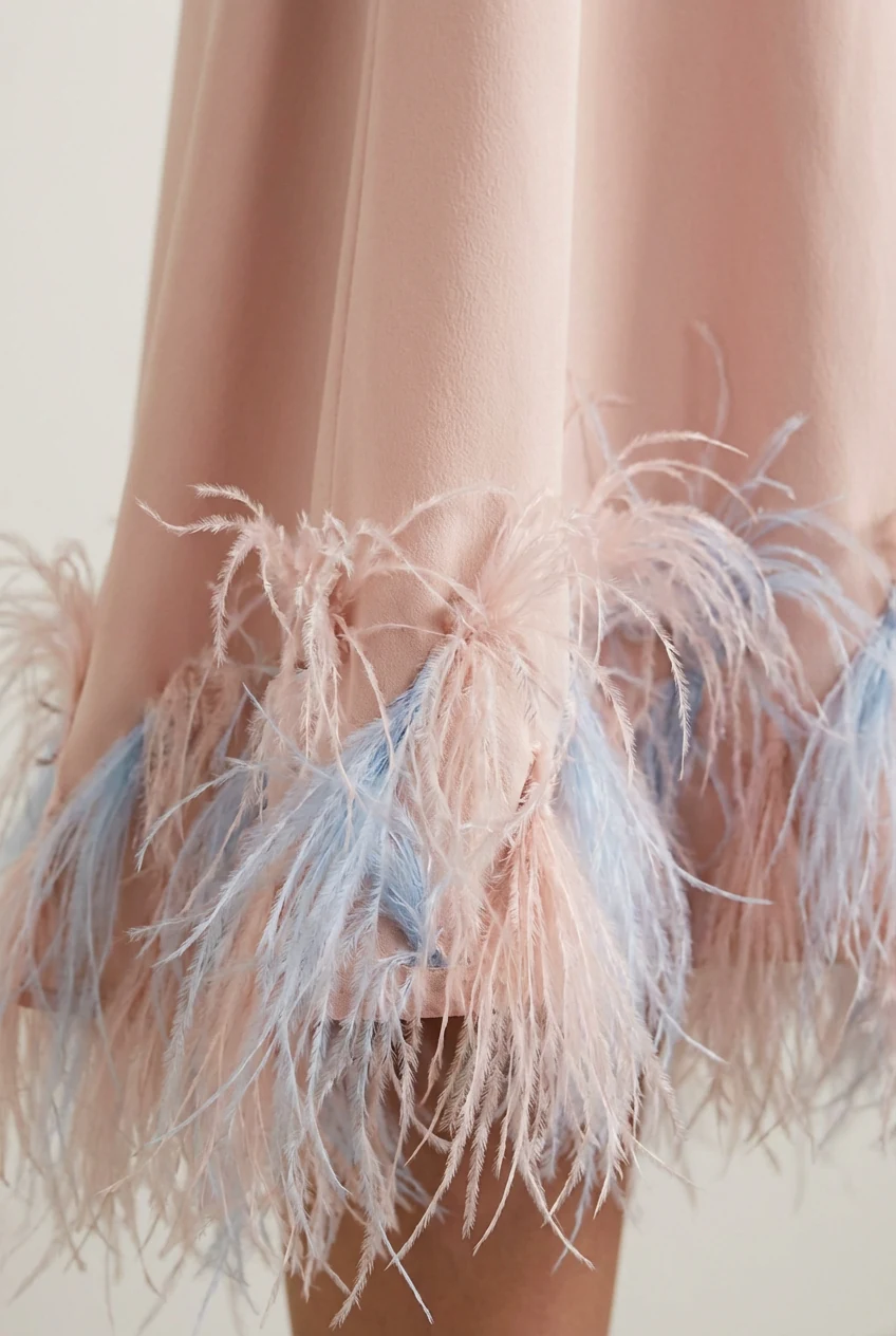 detail shot of feather trim on pastel midi dress